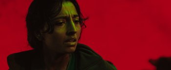 Movie still from “In the Earth” (2021), directed by Ben Wheatley – A woman with green paint on her face; Close Up shot, Overhead angle