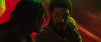 Movie still from “In the Earth” (2021), directed by Ben Wheatley – A man and a woman are talking in a dark room; Close Up shot, Over the shoulder angle