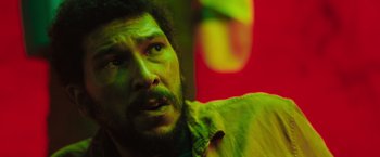 Movie still from “In the Earth” (2021), directed by Ben Wheatley – A person wearing a green shirt; Close Up shot, Low angle