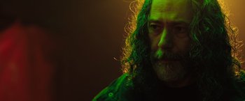 Movie still from “In the Earth” (2021), directed by Ben Wheatley – A person with long curly hair; Close Up shot, Low angle