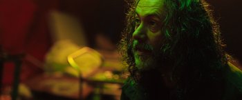 Movie still from “In the Earth” (2021), directed by Ben Wheatley – A person wearing a black shirt; Close Up shot, Low angle