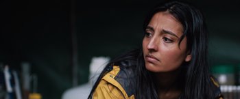 Movie still from “In the Earth” (2021), directed by Ben Wheatley – A person with long black hair; Close Up shot, Over the shoulder angle