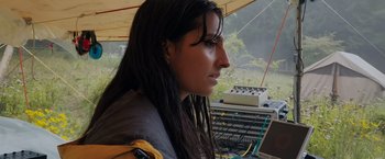 Movie still from “In the Earth” (2021), directed by Ben Wheatley – A woman sitting in front of a computer monitor; Close Up shot, Low angle