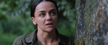 Movie still from “In the Earth” (2021), directed by Ben Wheatley – A person near a tree; Close Up shot, Over the shoulder angle