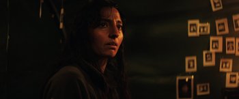 Movie still from “In the Earth” (2021), directed by Ben Wheatley – A person with long black hair; Close Up shot, Low angle