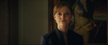 Movie still from “Independence Day: Resurgence” (2016), directed by Roland Emmerich – A woman with red hair wearing a black jacket; Close Up shot, Over the shoulder angle