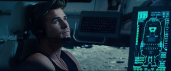 Movie still from “Independence Day: Resurgence” (2016), directed by Roland Emmerich – A man with a headset looking up at a laptop; Close Up shot, Over the shoulder angle
