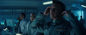 Movie still from “Independence Day: Resurgence” (2016), directed by Roland Emmerich – A group of men standing next to each other in a room; Close Up shot, Low angle