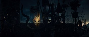 Movie still from “Independence Day: Resurgence” (2016), directed by Roland Emmerich – A lot of masks on display in the dark; Extreme Close Up shot, Low angle