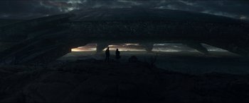 Movie still from “Independence Day: Resurgence” (2016), directed by Roland Emmerich – Two people standing on a cliff looking out into the sky; Extreme Wide shot, Low angle