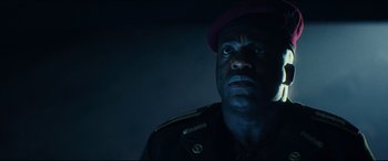 Movie still from “Independence Day: Resurgence” (2016), directed by Roland Emmerich – A man in a military uniform stares into the camera; Close Up shot, Low angle
