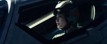 Movie still from “Independence Day: Resurgence” (2016), directed by Roland Emmerich – A person wearing a helmet sitting in a car; Close Up shot, Low angle