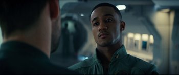 Movie still from “Independence Day: Resurgence” (2016), directed by Roland Emmerich – A person wearing a green jacket; Close Up shot, Over the shoulder angle