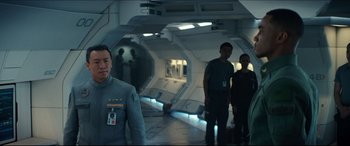 Movie still from “Independence Day: Resurgence” (2016), directed by Roland Emmerich – A group of people standing in a room; Medium shot, Over the shoulder angle