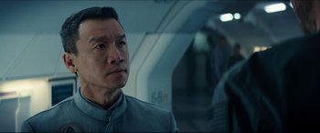 Movie still from “Independence Day: Resurgence” (2016), directed by Roland Emmerich – A man in a gray jacket looking at the camera; Close Up shot, Over the shoulder angle