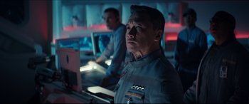 Movie still from “Independence Day: Resurgence” (2016), directed by Roland Emmerich – A man standing in front of a computer monitor; Medium shot, Over the shoulder angle