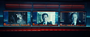 Movie still from “Independence Day: Resurgence” (2016), directed by Roland Emmerich – A man in a suit and tie on a television screen; Medium shot, Over the shoulder angle