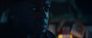 Movie still from “Independence Day: Resurgence” (2016), directed by Roland Emmerich – A man's face in the dark; Close Up shot, Over the shoulder angle