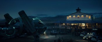 Movie still from “Independence Day: Resurgence” (2016), directed by Roland Emmerich – A group of people standing in a dirt field; Extreme Wide shot, Low angle