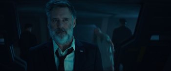 Movie still from “Independence Day: Resurgence” (2016), directed by Roland Emmerich – A man in a suit and a red tie; Medium shot, Low angle