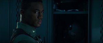 Movie still from “Independence Day: Resurgence” (2016), directed by Roland Emmerich – A man in a military uniform is looking at the camera; Close Up shot, Over the shoulder angle
