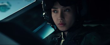 Movie still from “Independence Day: Resurgence” (2016), directed by Roland Emmerich – A woman wearing a helmet in the dark; Close Up shot, Low angle