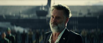 Movie still from “Independence Day: Resurgence” (2016), directed by Roland Emmerich – A person wearing a suit and beard; Close Up shot, Low angle