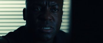 Movie still from “Independence Day: Resurgence” (2016), directed by Roland Emmerich – A man's face in the dark; Close Up shot, Low angle