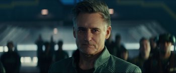 Movie still from “Independence Day: Resurgence” (2016), directed by Roland Emmerich – A person wearing a green shirt; Close Up shot, Over the shoulder angle