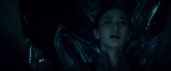 Movie still from “Independence Day: Resurgence” (2016), directed by Roland Emmerich – A man laying on the ground in a dark room; Close Up shot, Overhead angle
