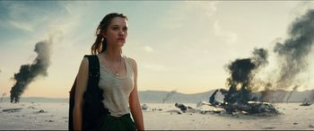 Movie still from “Independence Day: Resurgence” (2016), directed by Roland Emmerich – A woman standing on the beach looking at the camera; Medium shot, Low angle