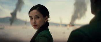 Movie still from “Independence Day: Resurgence” (2016), directed by Roland Emmerich – A young woman is posing for a picture; Close Up shot, Over the shoulder angle