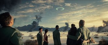 Movie still from “Independence Day: Resurgence” (2016), directed by Roland Emmerich – A group of people standing on top of a sandy beach; Extreme Wide shot, Over the shoulder angle