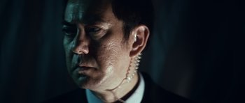 Movie still from “Infernal Affairs” (2002), directed by Alan Mak – A person wearing ear buds; Close Up shot, Low angle