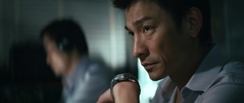 Movie still from “Infernal Affairs” (2002), directed by Alan Mak – A person wearing a wrist watch; Close Up shot, Low angle