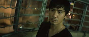 Movie still from “Infernal Affairs” (2002), directed by Alan Mak – A person wearing a black shirt; Close Up shot, High angle