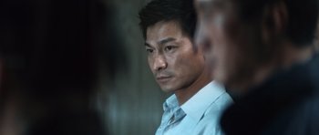 Movie still from “Infernal Affairs” (2002), directed by Alan Mak – A person wearing a white shirt; Close Up shot, Low angle