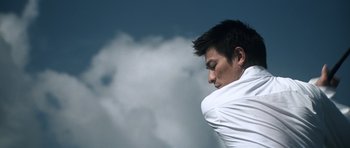 Movie still from “Infernal Affairs” (2002), directed by Alan Mak – A man in a white shirt is looking down; Medium shot, Low angle