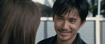 Movie still from “Infernal Affairs” (2002), directed by Alan Mak – A person with long black hair; Close Up shot, Over the shoulder angle
