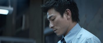 Movie still from “Infernal Affairs” (2002), directed by Alan Mak – A person wearing a shirt and tie; Close Up shot, Low angle