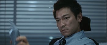 Movie still from “Infernal Affairs” (2002), directed by Alan Mak – A person wearing a shirt and a tie; Close Up shot, Low angle
