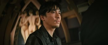 Movie still from “Infernal Affairs” (2002), directed by Alan Mak – A person wearing a black shirt; Close Up shot, Low angle