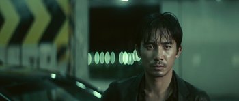 Movie still from “Infernal Affairs” (2002), directed by Alan Mak – A person wearing a jacket; Close Up shot, Low angle