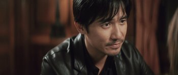 Movie still from “Infernal Affairs” (2002), directed by Alan Mak – A person wearing a leather jacket; Close Up shot, High angle
