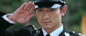 Movie still from “Infernal Affairs” (2002), directed by Alan Mak – A person saluting wearing a uniform; Close Up shot, Low angle