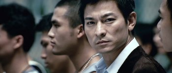 Movie still from “Infernal Affairs” (2002), directed by Alan Mak – Two asian men standing next to each other; Close Up shot, Low angle