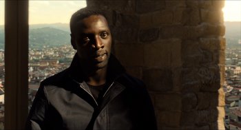 Movie still from “Inferno” (2016), directed by Ron Howard – A man standing in front of a brick wall; Close Up shot, Low angle