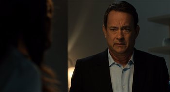 Movie still from “Inferno” (2016), directed by Ron Howard – A man wearing a suit and tie standing in front of a mirror; Close Up shot, Over the shoulder angle