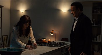 Movie still from “Inferno” (2016), directed by Ron Howard – A man and a woman standing next to each other in front of a stove; Medium shot, High angle