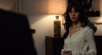 Movie still from “Inferno” (2016), directed by Ron Howard – A woman standing in front of a mirror holding a cell phone; Close Up shot, Over the shoulder angle